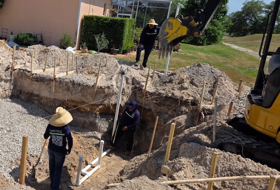 Handy Pools LLC crew working on pool excavation with heavy equipment in Florida