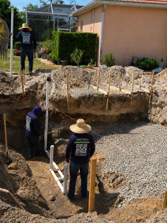 Handy Pools LLC team working on pool excavation and plumbing installation at a residential property in Florida